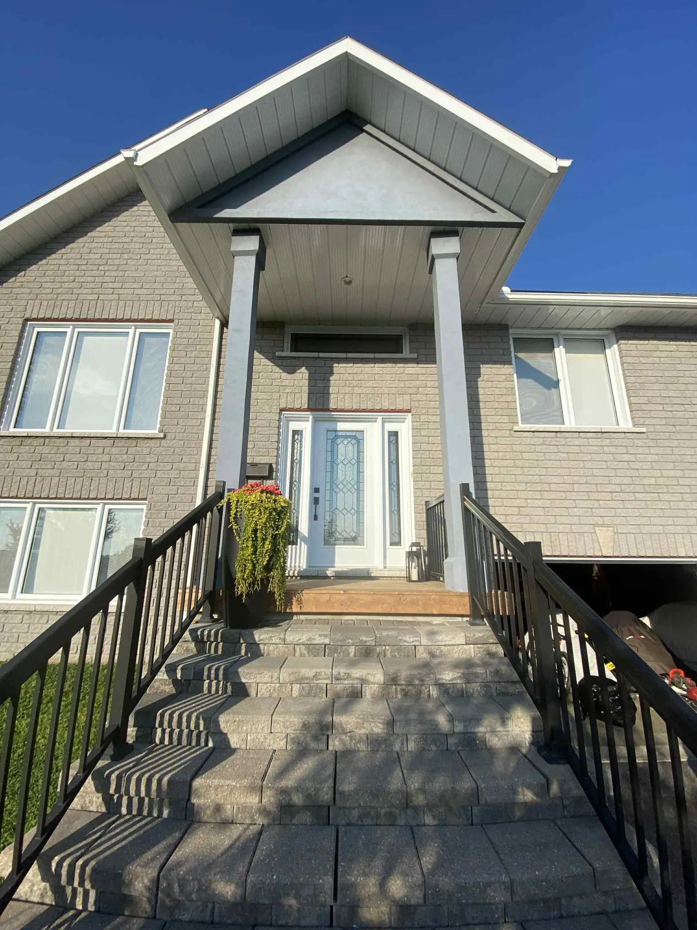 Two-storey North Bay home before exterior repaint with original siding colour