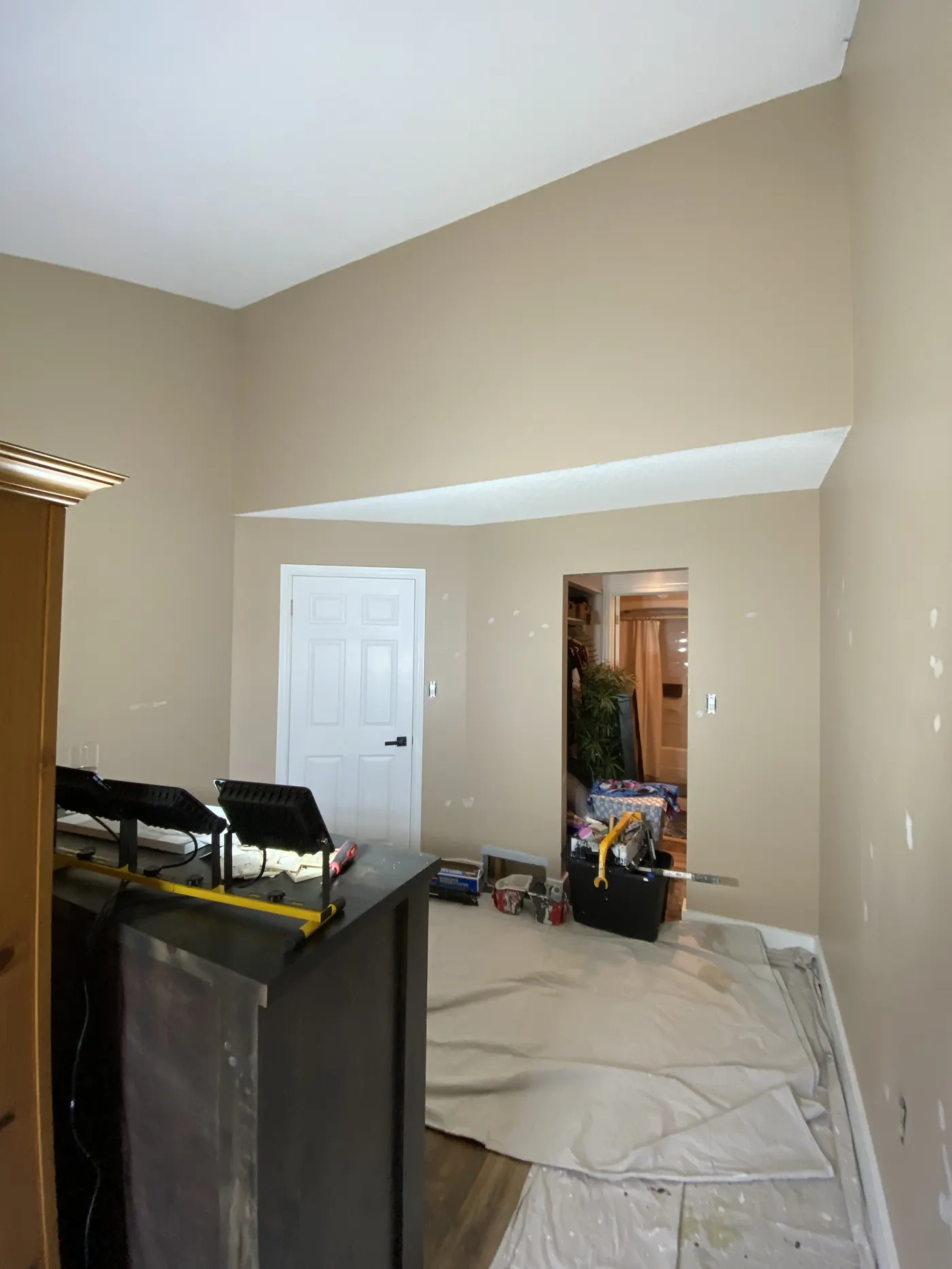 Foyer and staircase before interior repaint, original dark walls in a North Bay home