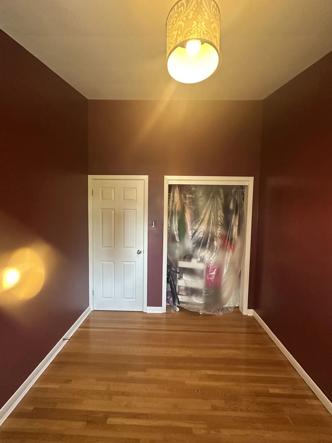 Bedroom with dramatic dark accent wall painted by All In One Painting