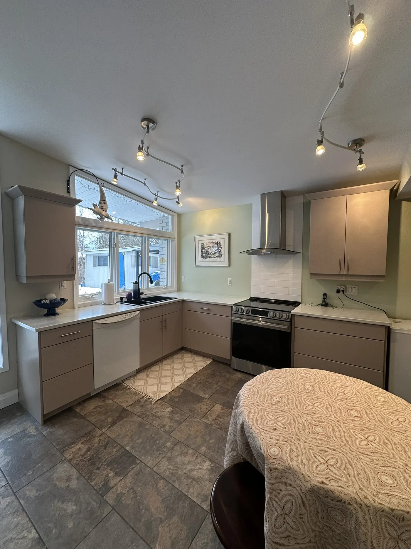 Cream painted kitchen cabinets with stained island finished by All In One Painting